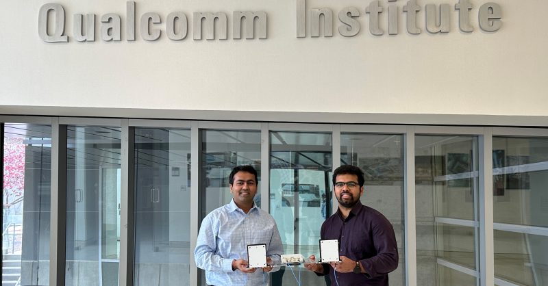 Study authors Dinesh Bharadia (left) and Rohith Reddy Vennam (right) stand inside the UC San Diego Qualcomm Institute with a prototype mmSpoof device.