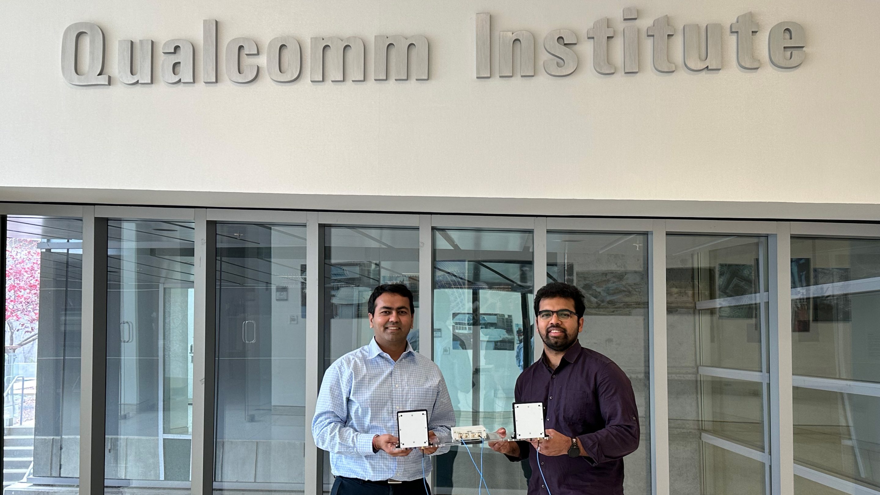 Study authors Dinesh Bharadia (left) and Rohith Reddy Vennam (right) stand inside the UC San Diego Qualcomm Institute with a prototype mmSpoof device.