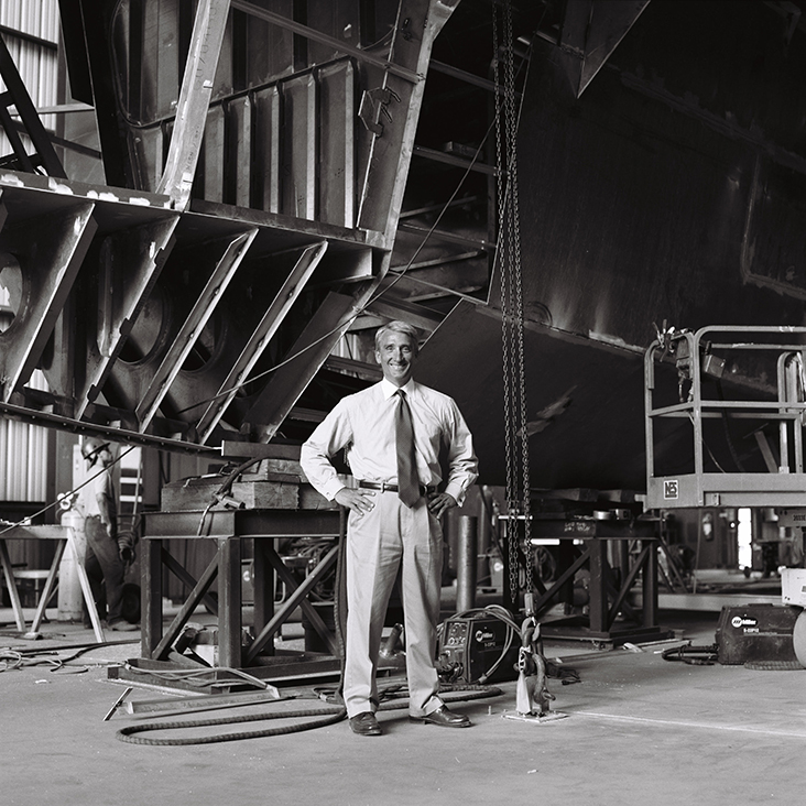 Man in front of ship in warehouse